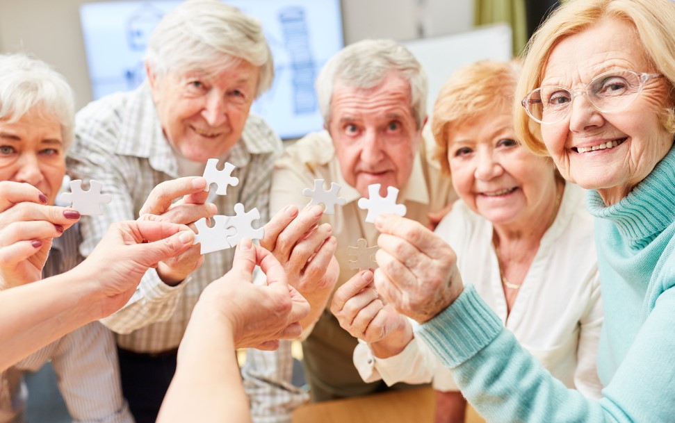 A photo of people around the age of 65 at the respite care suffering from young onset dementia doing jigsaw puzzle