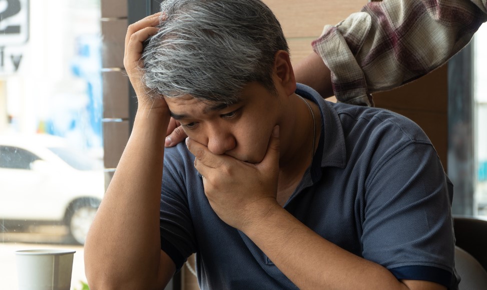 Middle-aged Asian man 55 years old, stressed and worried about the signs of early dementia